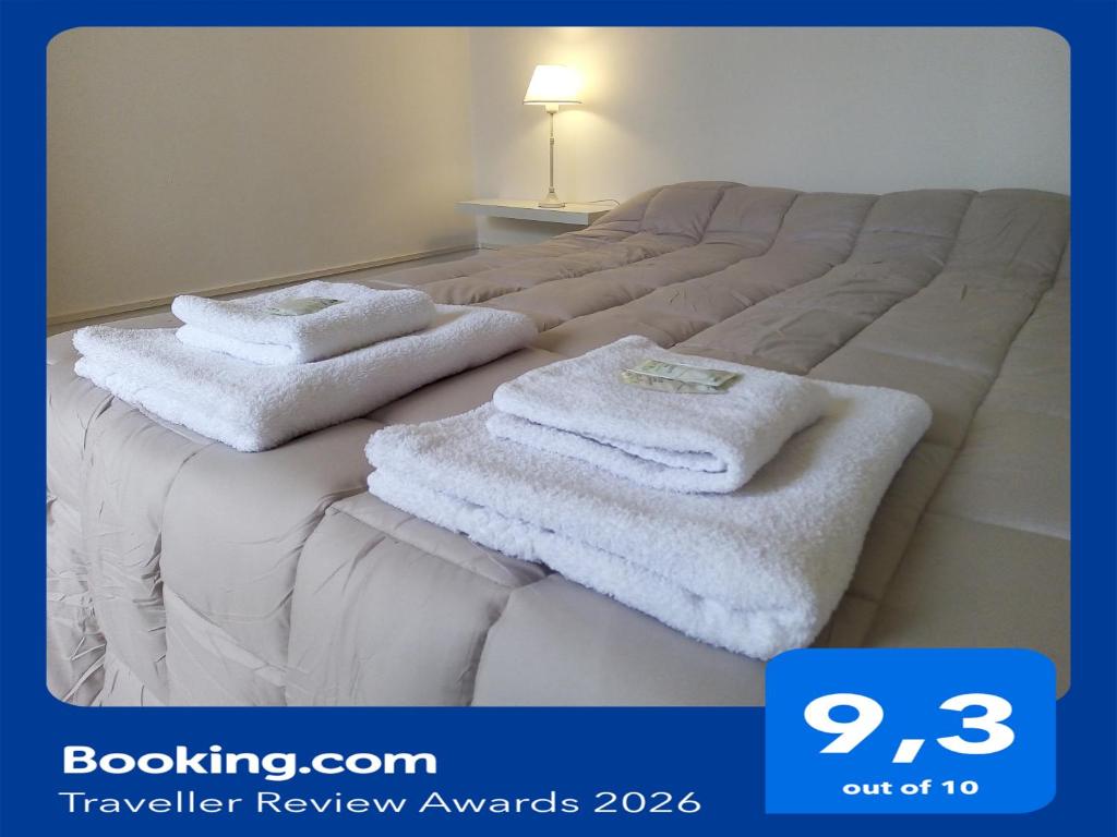 a bed with two white towels on top of it at Urquiza - Habitación para turistas in Córdoba