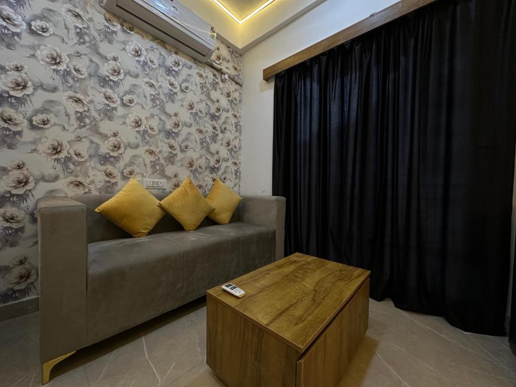 a living room with a couch and a table at Premium Studio Appartment in Māripat