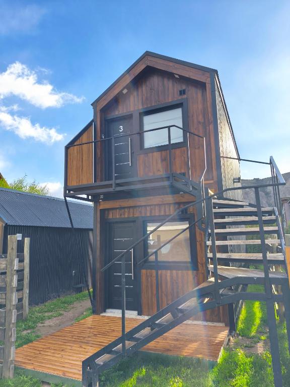 a tree house with a staircase leading up to it at Patagonia Tiny house 3 in El Chalten