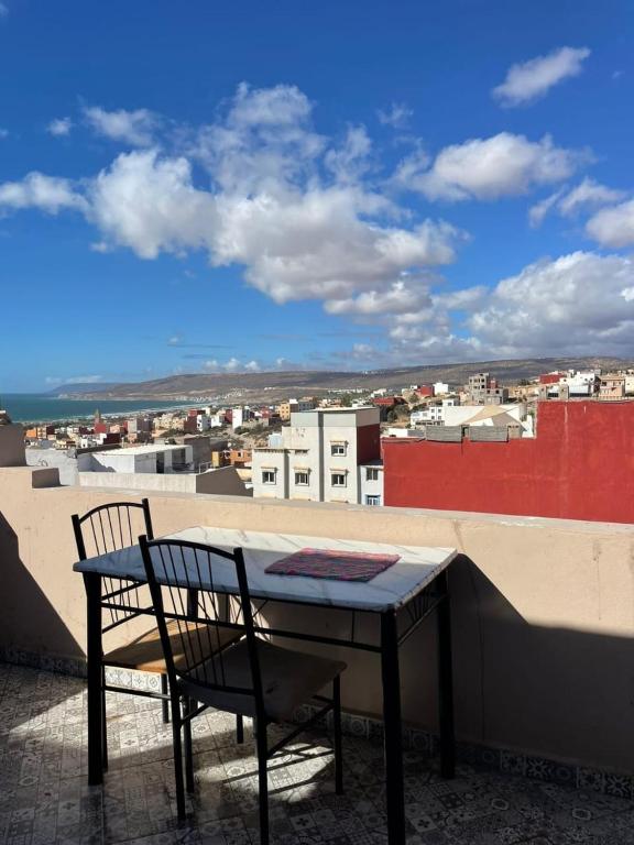 a table and chair on top of a roof at Chez Manon & Said in Tamraght Ouzdar