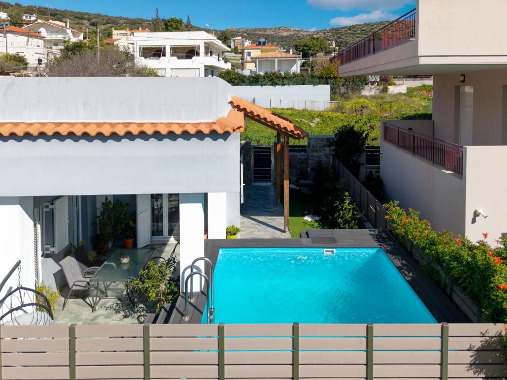 a view of the pool from the balcony of a house at Porto Blue Heaven in Porto Rafti