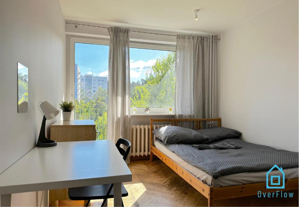 a bedroom with a bed and a desk and a window at Array Room - 5 Minutes to Sopot Molo & Seaside in Sopot