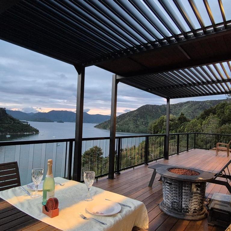 a table on a deck with a view of the water at Bayheights in Picton