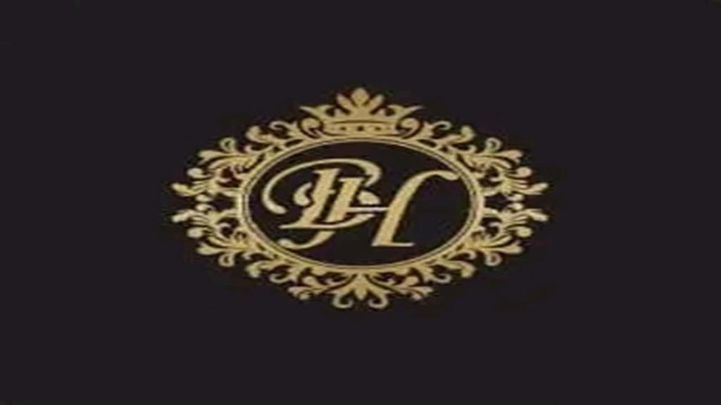 a gold logo with a letter l on a black background at Bromford Hotel Owerri in Owerri