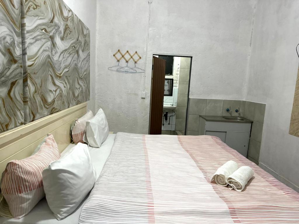 a bedroom with a bed with two towels on it at Blue Guesthouse in Virginia