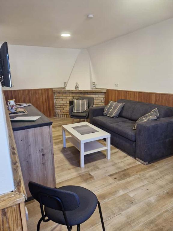 a living room with a couch and a table at Sklípek u Štýblů in Velké Němčice