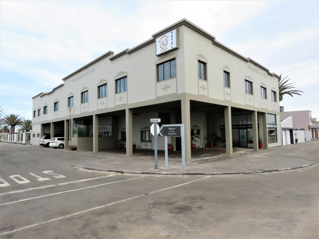 a large white building with a clock on the front at Ngandu at Sea in Meersig