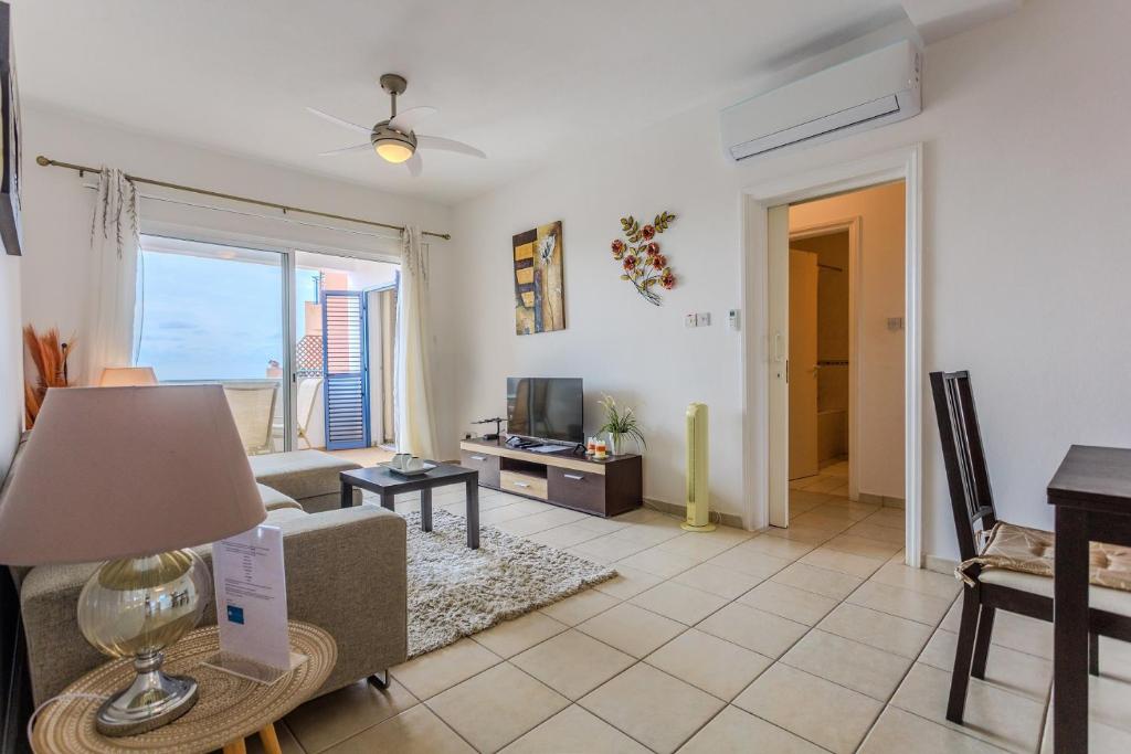 a living room with a couch and a table at Resitour - Tala Hills in Tala