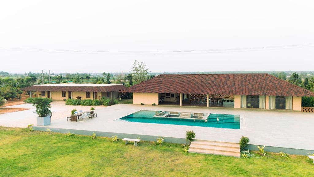 an aerial view of a house with a swimming pool at Krsna Farm Villa in Bangalore