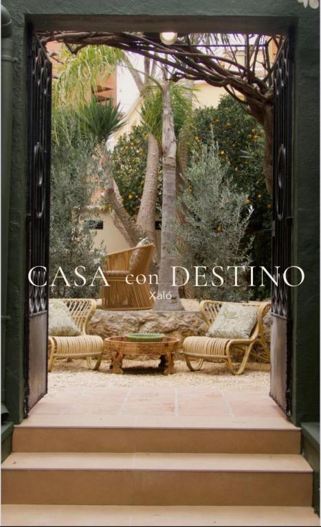 an entrance to a garden with a bench and trees at Casa Con Destino in Jalón