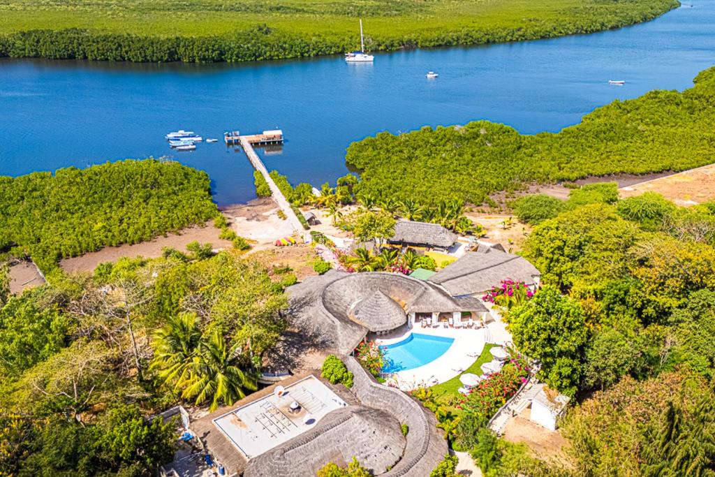 an aerial view of a house next to a lake at Keur Saloum Resort in Toubakouta