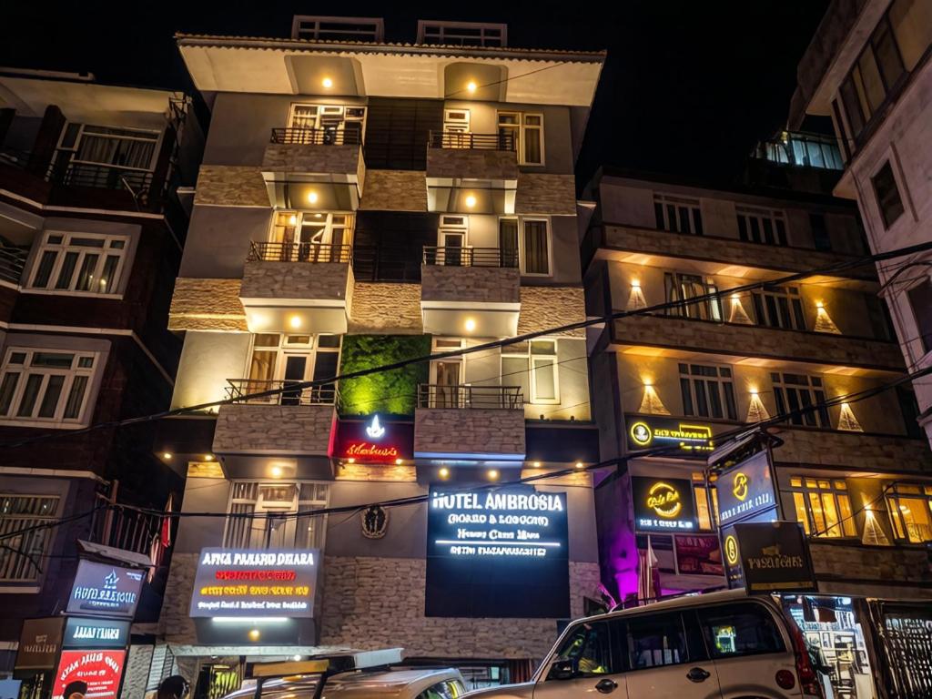 a building at night with cars parked in front of it at Hotel Ambrosia in Gangtok