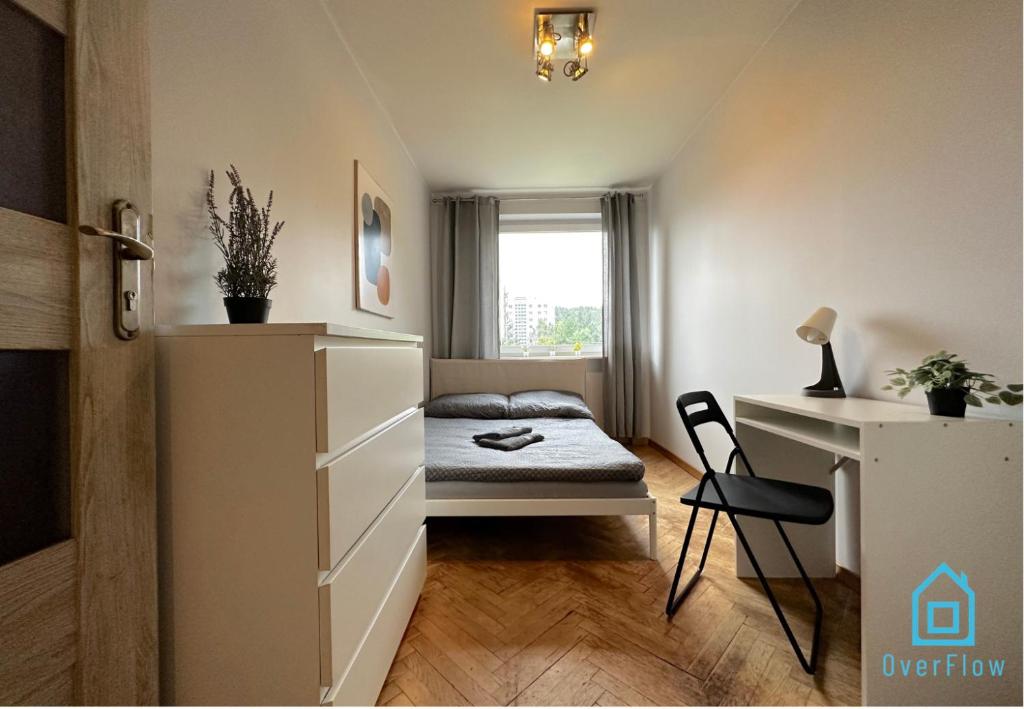 a small bedroom with a bed and a desk at Funky Room - 5 Minutes to Sopot Molo & Seaside in Sopot