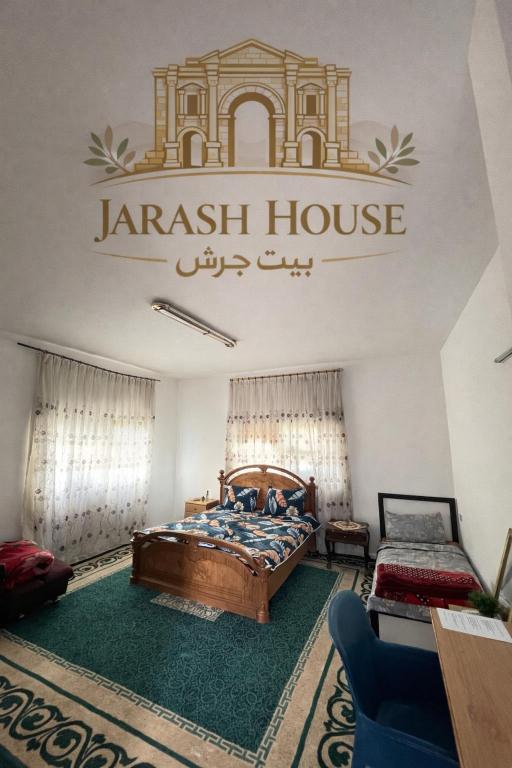 a bedroom with a bed and a sign on the wall at بيت جرش - Jerash House in Jerash