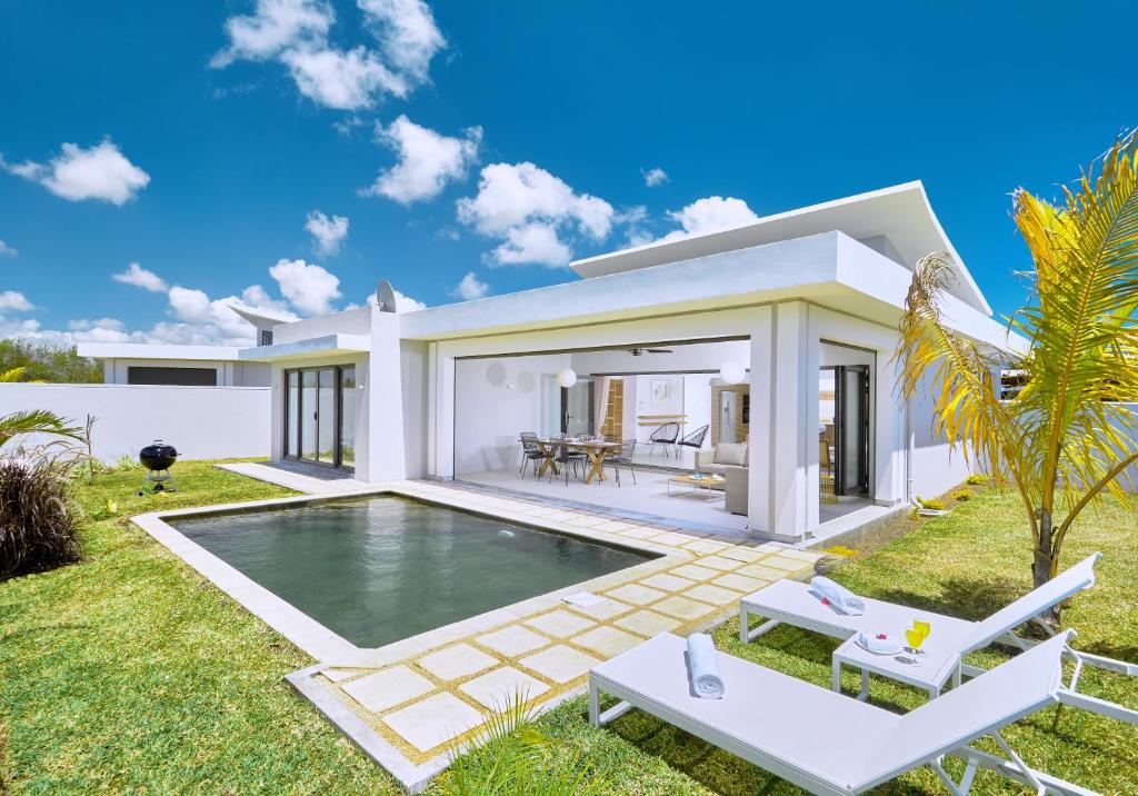 a villa with a swimming pool in a backyard at Corail Bleu 3-Bedroom Private Pool Villa by LOV Mauritius in Bain Boeuf