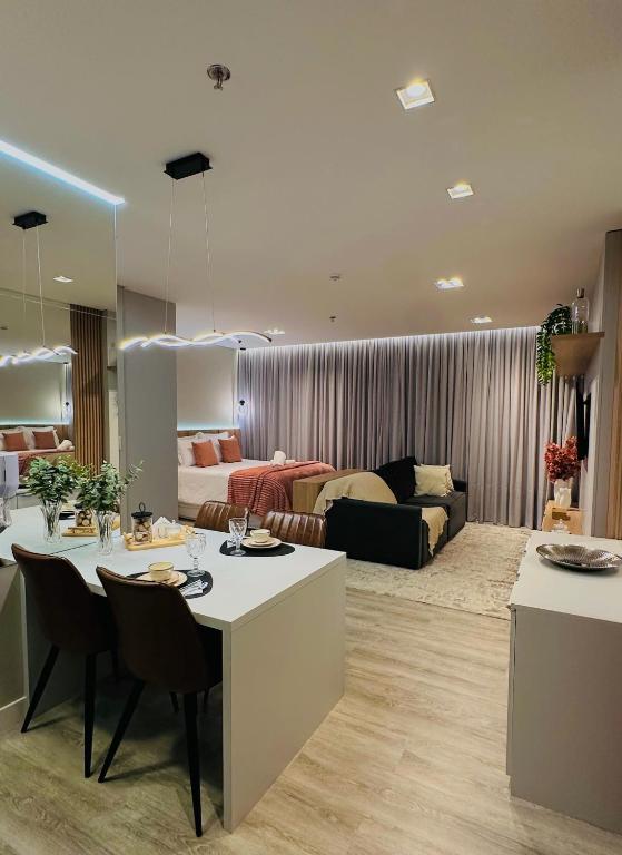 a kitchen and living room with a table and a couch at Infinity Tower Flat 1105 in Itapema