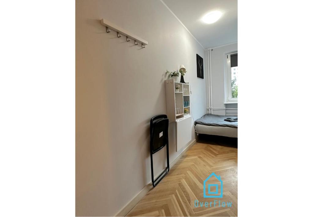 a living room with a bed and a hallway at Deer Room - 5 Minutes to Sopot Molo & Seaside in Sopot