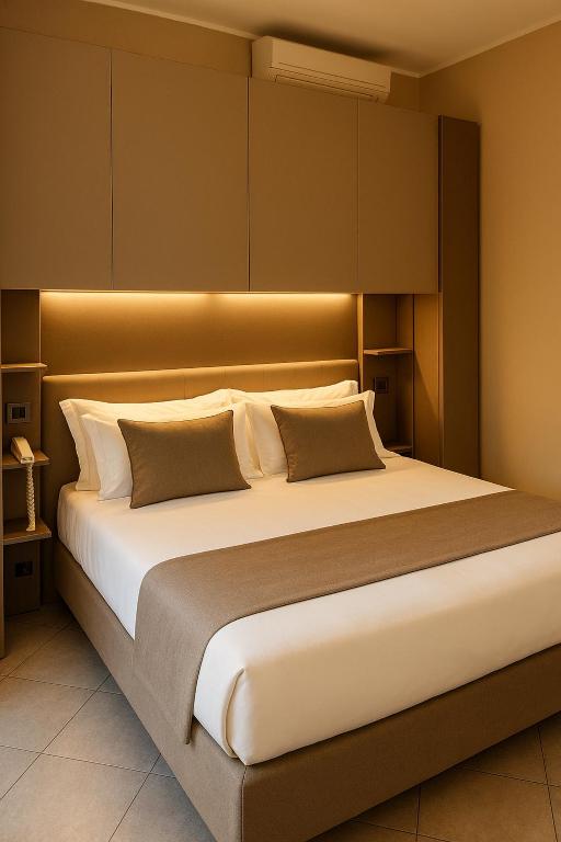 a bedroom with a large bed in a room at Hotel SoleMare in Diano Marina