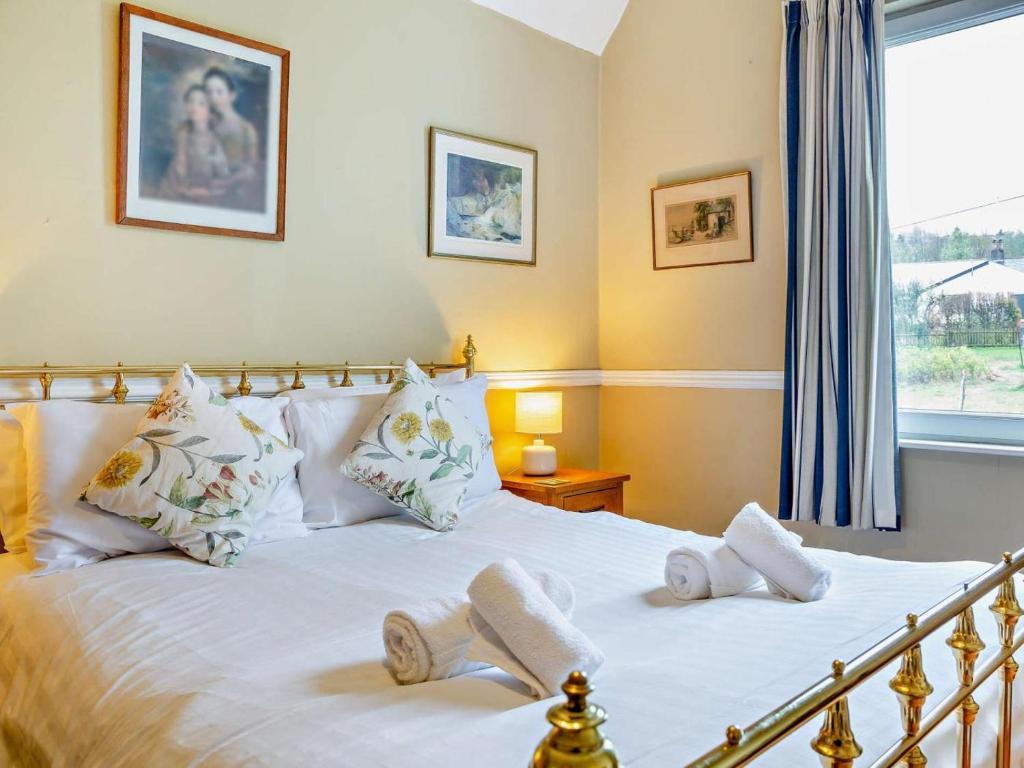 a bedroom with a white bed with a window at 3 Bed in Keswick oc-sz135 in Threlkeld