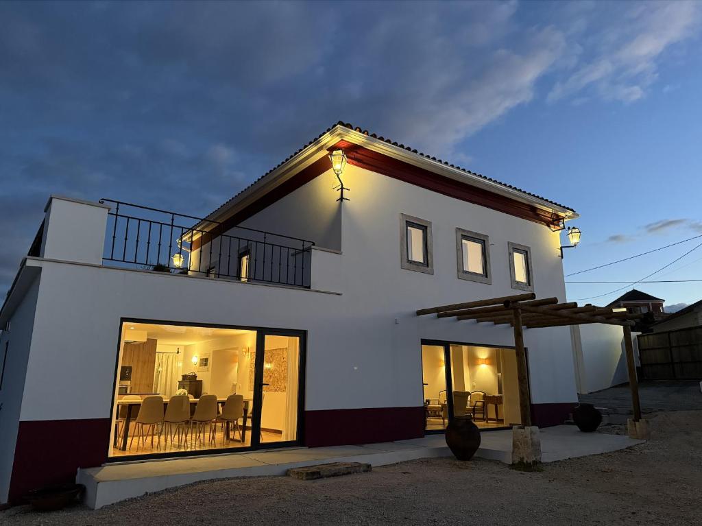a large white house with a balcony and windows at AlcaidariaVista in Ourém
