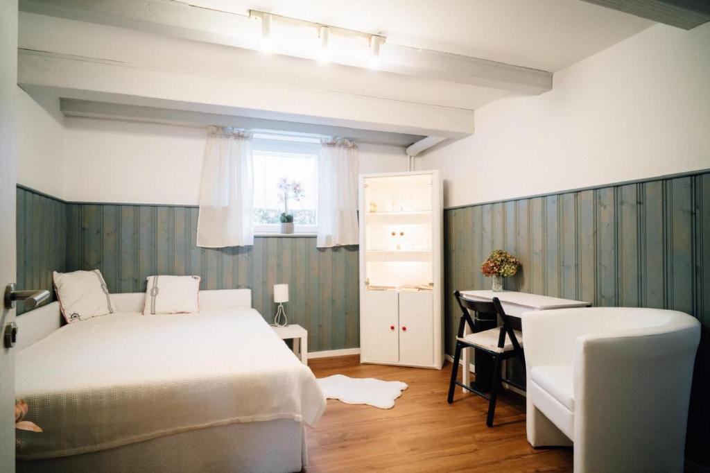 a bedroom with a bed and a desk and a window at Ferienwohnung Gierschner in Kronach