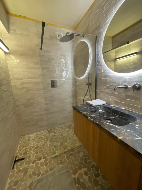 a bathroom with a sink and a mirror at logies One Room, Sea view in Ostend