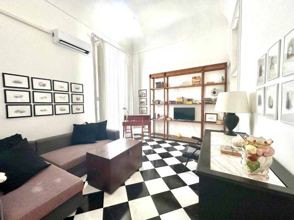 a living room with a couch and a table at Milonghita Apartment Ortigia by Ortigiaapartments in Syracuse