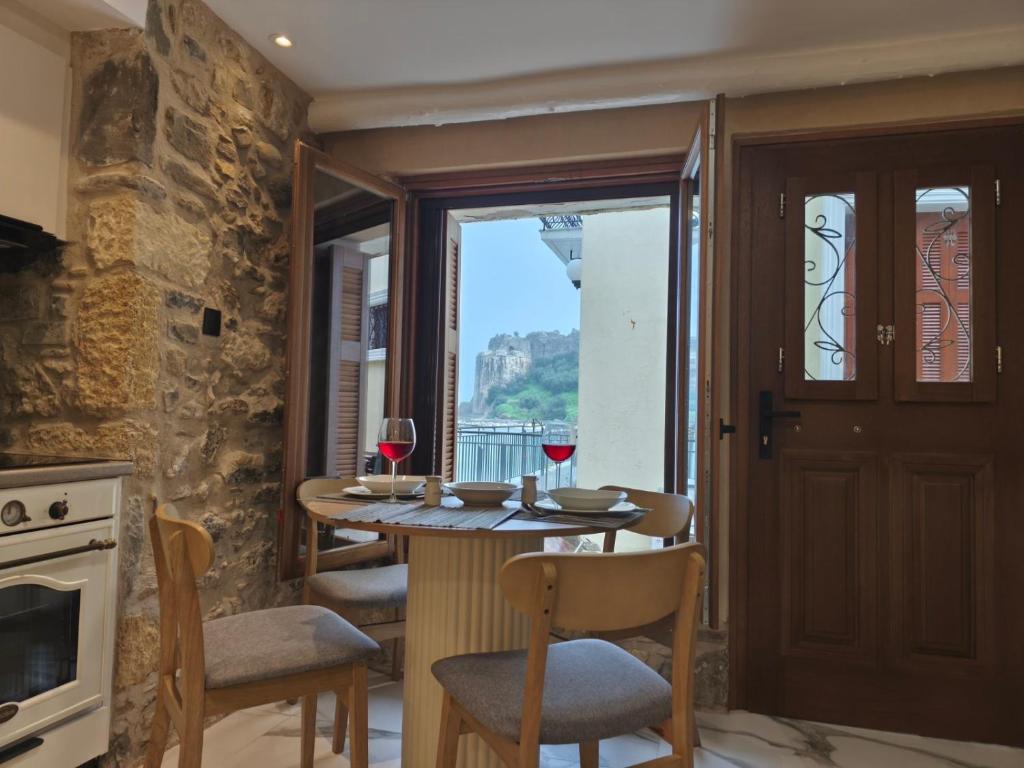 a kitchen with a table with two glasses of wine at Castle View Serenity in Koroni