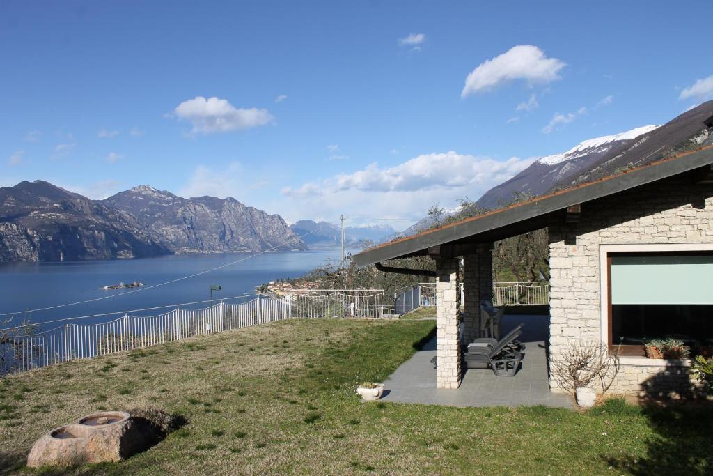 a house with a view of the water and mountains at Villa Manuela-Lake View in Brenzone sul Garda