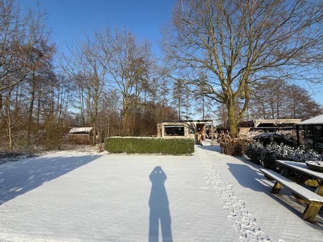 a shadow of a person standing in the snow at Buitenverwachting in Heelweg