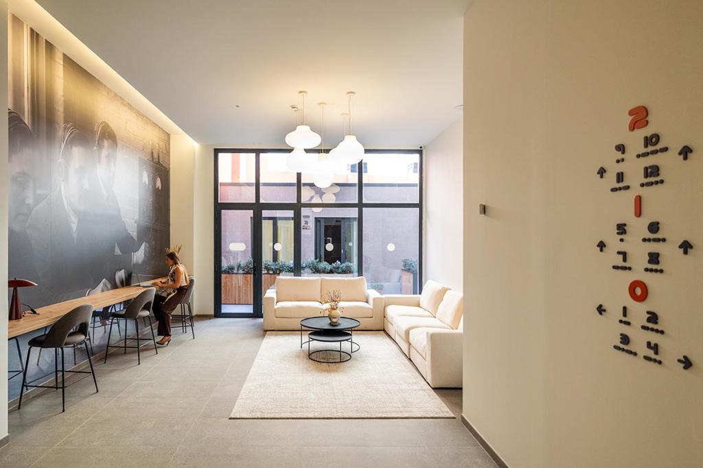 a living room with a couch and a table at Brabo Apartments in Hospitalet de Llobregat