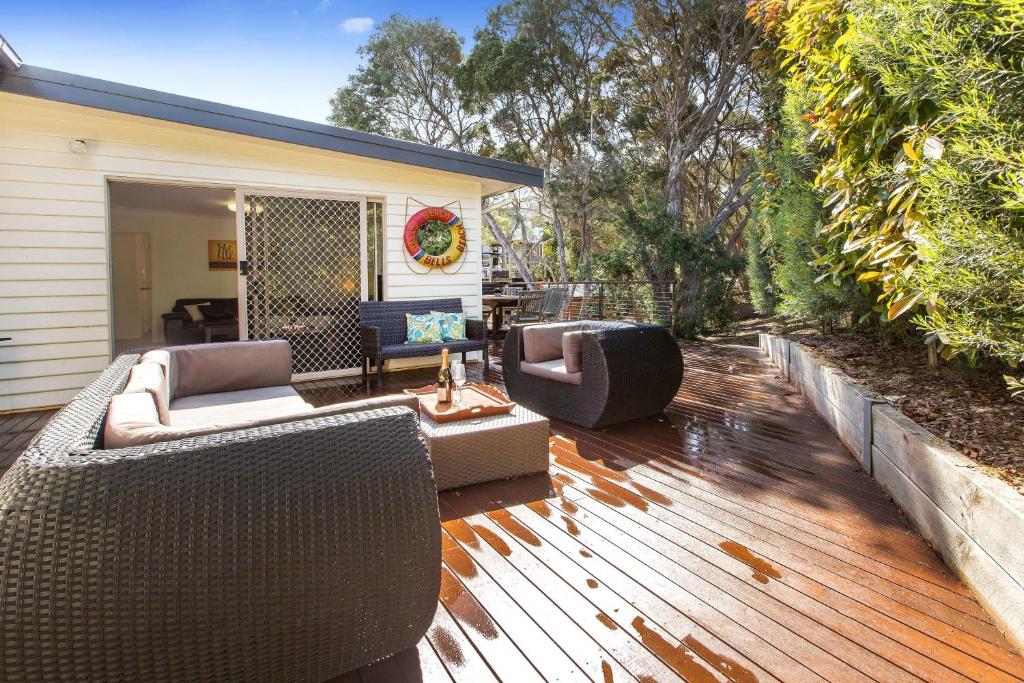 a patio with two couches and chairs on a wooden deck at Bonnie Blairgowrie in Blairgowrie