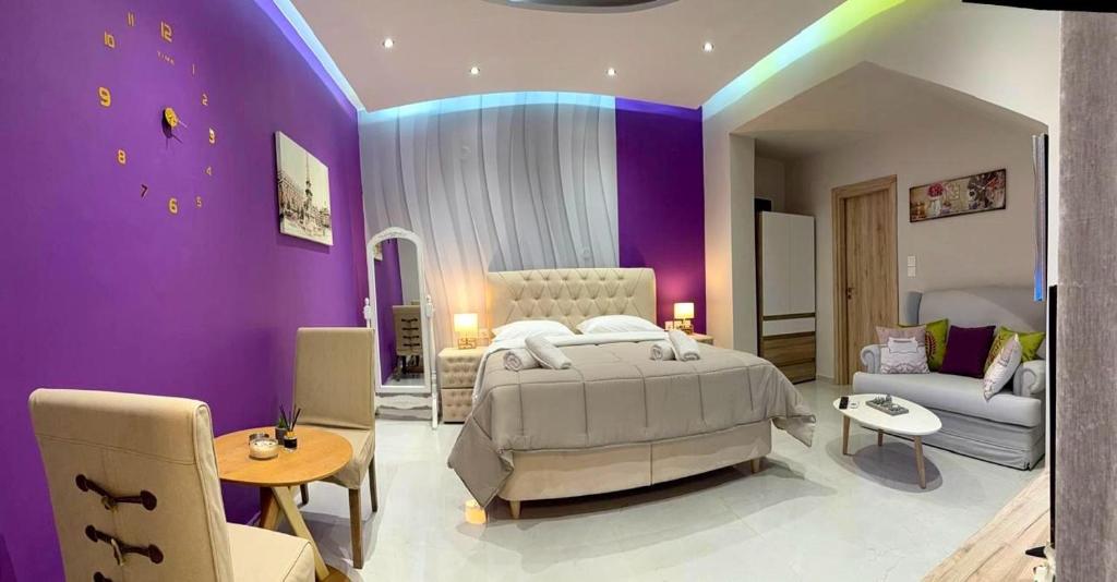 a bedroom with a bed and a purple wall at Aggelos Room 3 in Volos