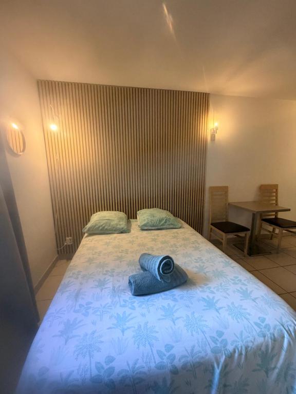 a bedroom with a bed with a blue blanket on it at Le Clos d'Aix studio 102 in Aix-en-Provence