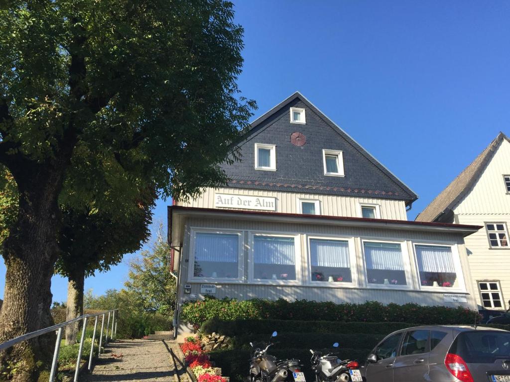 a house with a car parked in front of it at Eichhörnchenblick in Hahnenklee-Bockswiese