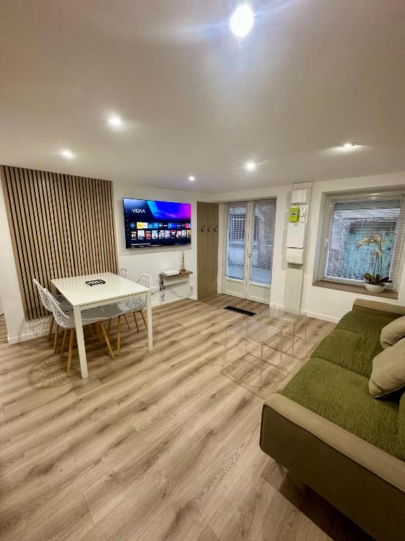 a living room with a couch and a table at Relax & Cosy Saint Just Saint Rambert in Saint-Rambert-sur-Loire
