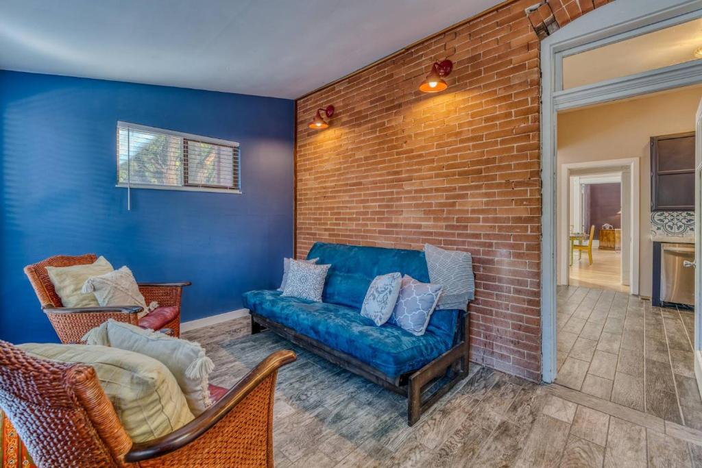 a living room with a couch and a brick wall at The Rosemont Estate in Florence
