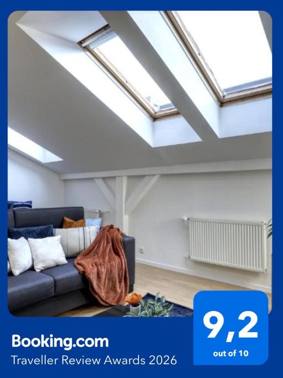 a living room with a couch and a skylight at Spacious Old Town LOFT for 6 in Bratislava