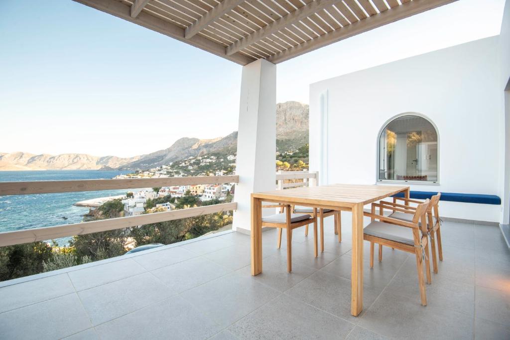 a dining room with a table and views of the ocean at Casa Mare Melitsahas - Panoramic Sea View in Kalymnos