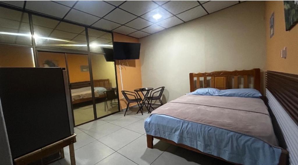 a bedroom with a bed and a tv in a room at Hospedaje Ofe,S #3 in Santiago