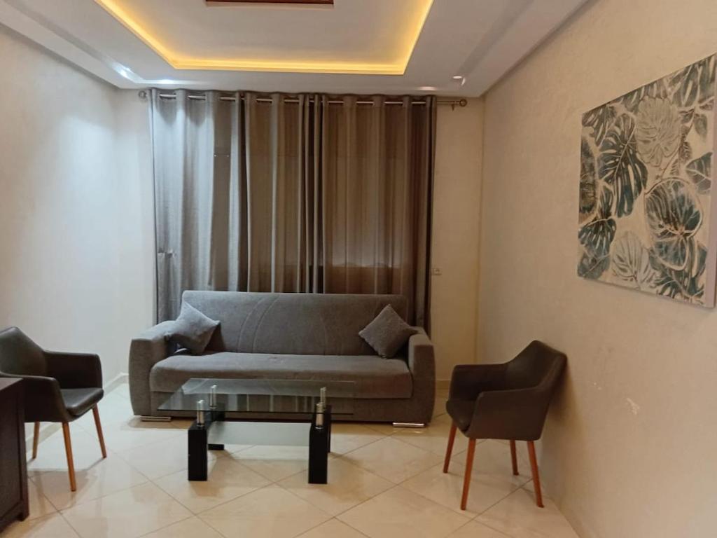 a living room with a couch and two chairs at Annakhil 30 in Oulad Akkou