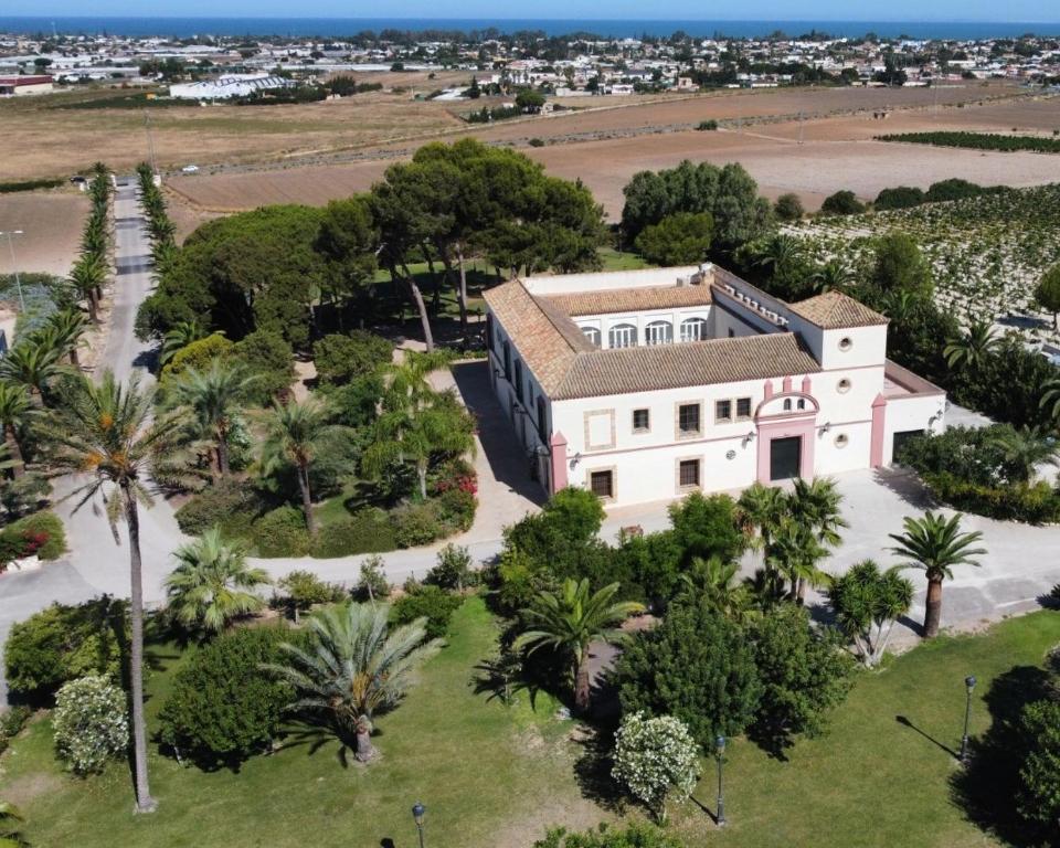 an aerial view of a house with palm trees at Casa Rural El Charruado in Sanlúcar de Barrameda