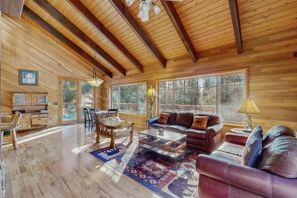 a living room with a couch and a table at Ponderosa Cabin in Bend