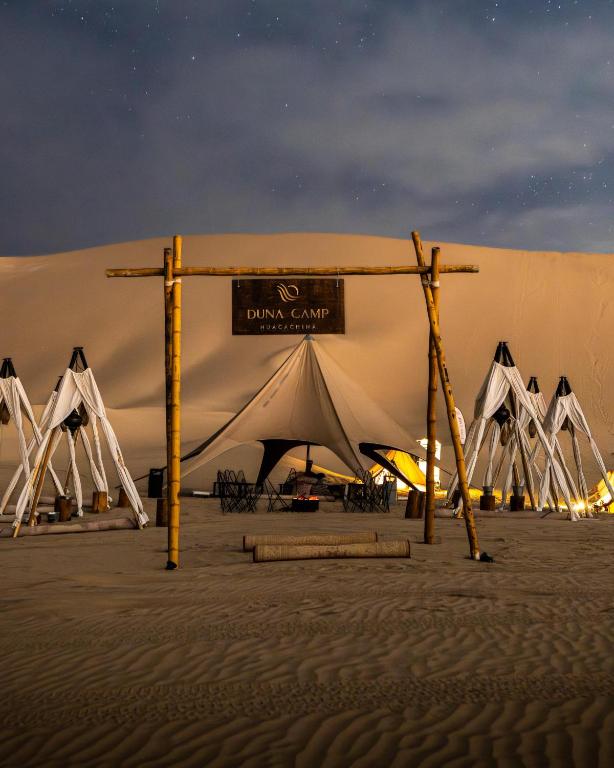 a large tent in the desert at night at Duna Camp Huacachina in Ica