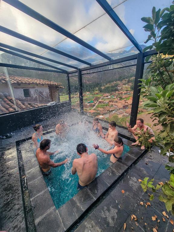 a group of men in the water in a pool at Wolf Totem Steam Punk Guesthouse in Pisac