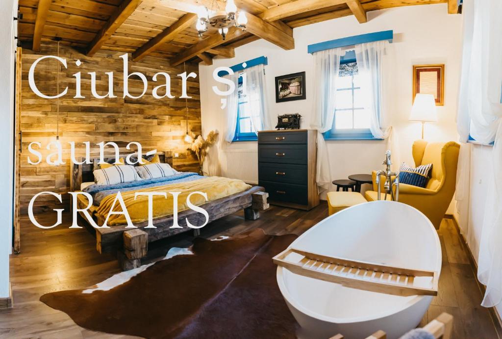 a bedroom with a bed and a bath tub at Emese Guesthouse in Şiclod