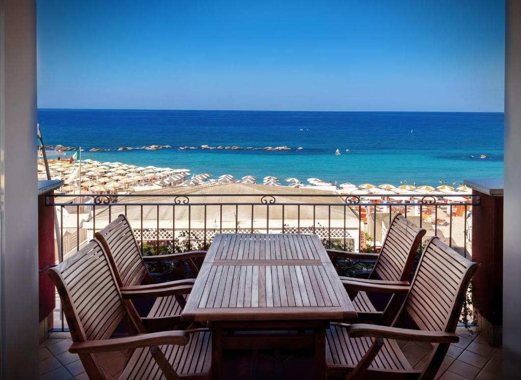 a table and chairs on a balcony with the beach at Fronte BLU - FRONTE MARE in Porto Recanati