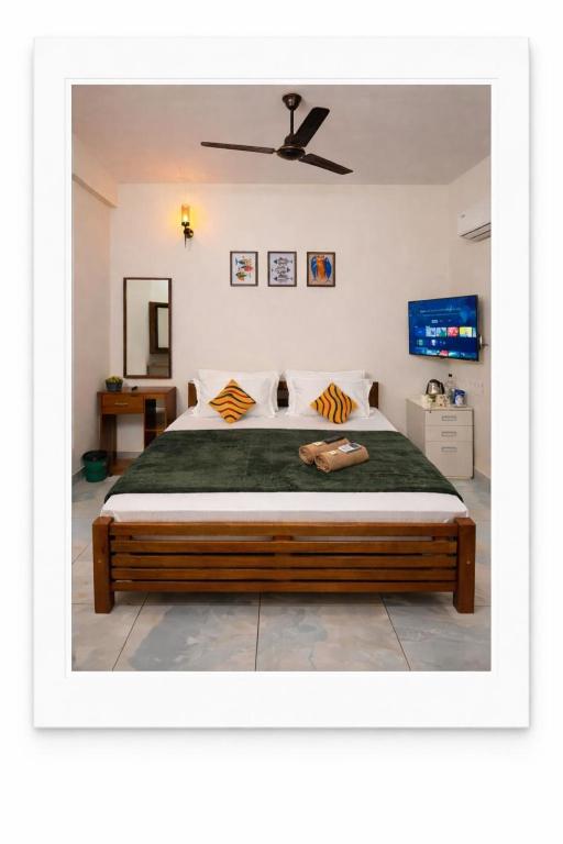 a bedroom with a large bed with a ceiling at hello 6 cliff stay varkalacliff - cozy rooms , couple friendly ,family ,group rooms in Varkala