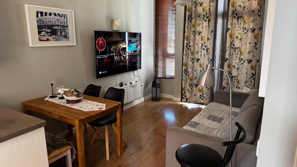 a living room with a table and a dining room at Apartamento en Playa del Ingles CC Yumbo in Maspalomas