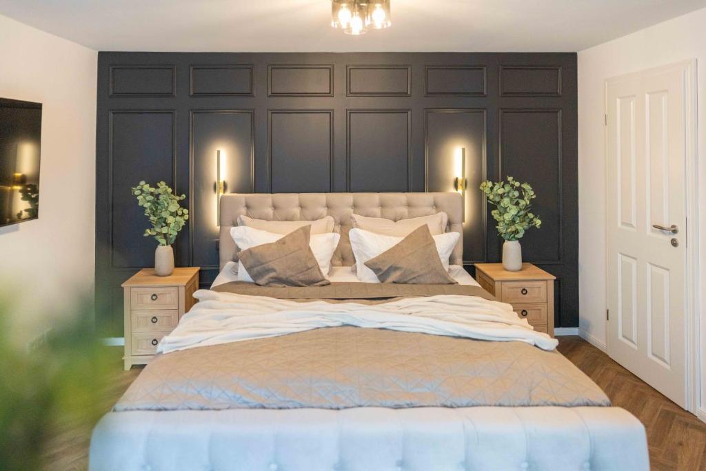 a bedroom with a large bed with two night stands at NORDÉA Apartments in Rostock